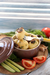 Young boiled potatoes in pan with vegetables