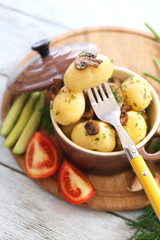 Young boiled potatoes in pan with vegetables