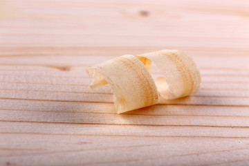 Wood shavings on wooden background closeup
