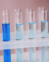 Test tubes with liquid on grey background