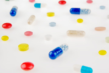 Color pills and capsules background isolated on white background