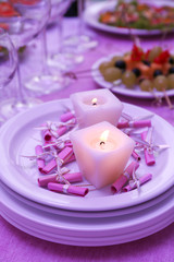 Buffet table with dishware and candles waiting for guests