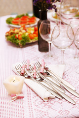 Buffet table with dishware and candle waiting for guests