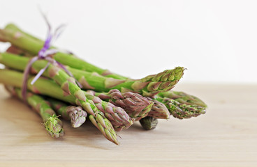 Espárragos verdes sujetos con cuerda de color púrpura