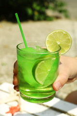 Refreshing cocktail in hand