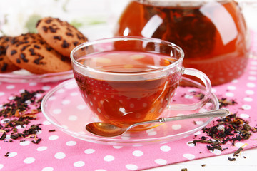 Teapot and cup of tea on table close-up