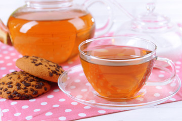 Teapot and cup of tea on table close-up