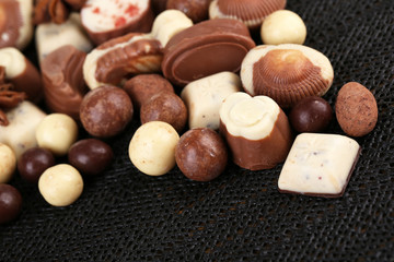 Different kinds of chocolates on dark background