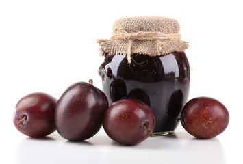 Plum jam and fresh plums isolated on white