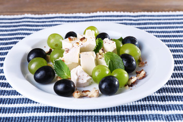 tasty salad with grape and cheese, close up