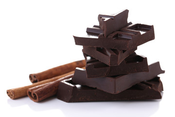 Cracked chocolate bar with spices isolated on white