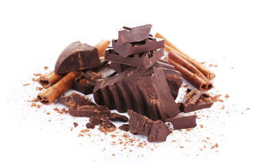 Cracked chocolate bar with spices isolated on white