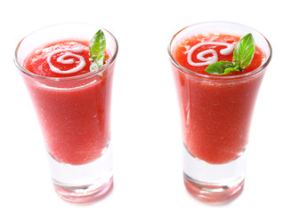 Gazpacho soup in two glasses isolated on white
