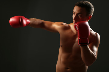 Plakat Handsome young muscular sportsman with boxing gloves