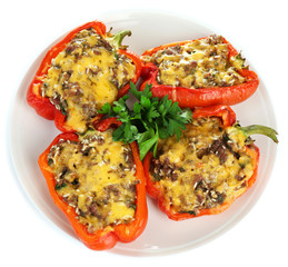 Stuffed red peppers on plate isolated on white