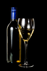 A glass and blue rit bottle of white wine