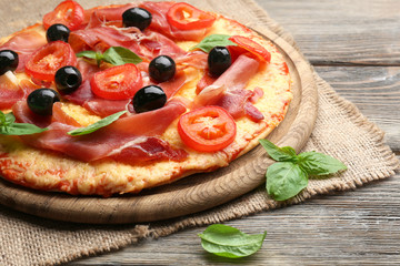Delicious pizza served on wooden table