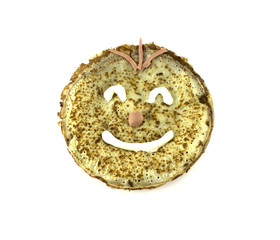 Painted a cheerful smiley pancakes. Isolated object on white bac