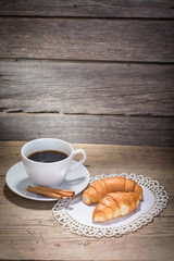 A cup of coffee and croissants