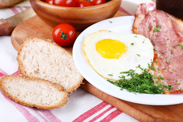 Scrambled eggs with bacon and vegetables served