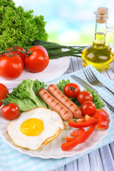 Scrambled egg with vegetables and sausage served in plate