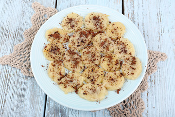 Sweetened fried banana on plate, close-up