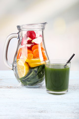 Jar of cut vegetables and glass of fresh vegetable juice with