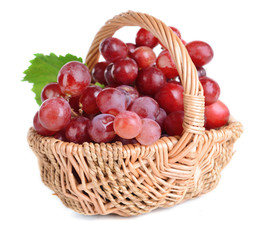 Sweet red grapes in wicker basket isolated on white