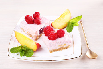 Cake with fruits and berries on plate on wooden background