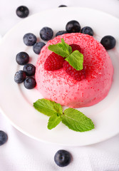 Round shaped cake with fruits and berries on plate on