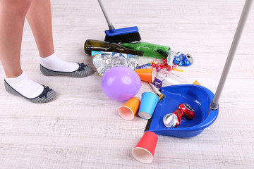 Woman cleaning grey wooden floor from mess
