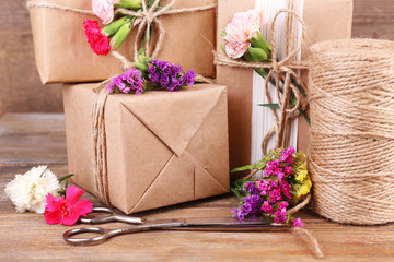 Beautiful gifts with flowers and decorative rope,