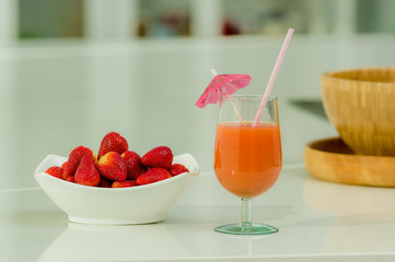 Delicous strawberry juice in a glass and fresh strawberries on