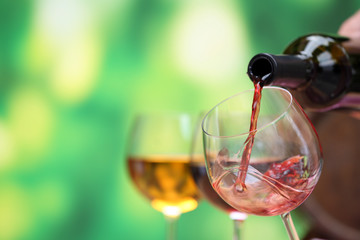 Red wine pouring into wine glass, close-up