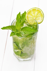 Lemonade with fresh lime and mint in glass