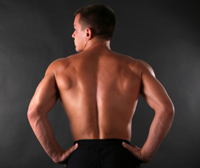 Handsome muscle young man on dark background