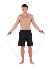 Handsome young sportsman jumping rope isolated on white