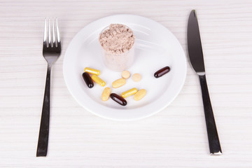 Whey protein powder in scoop with vitamins