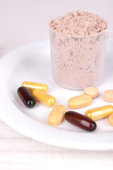 Whey protein powder in scoop with vitamins