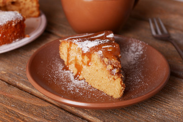 Delicious cake and cup of coffee on wooden table