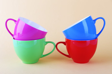 Colorful cups on color background