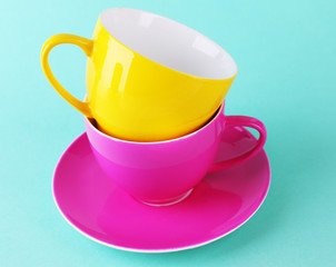 Colorful cups on color background
