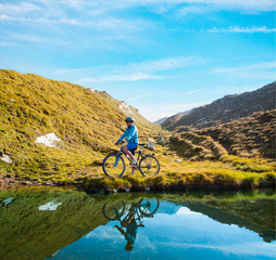 Fototapeta premium Cyclist woman in hight mountais