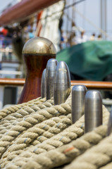 mooring rope tied on the bollards of old wooden ship