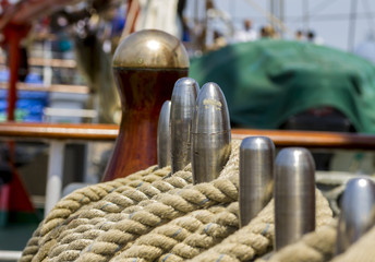 mooring rope tied on the bollards of old wooden ship