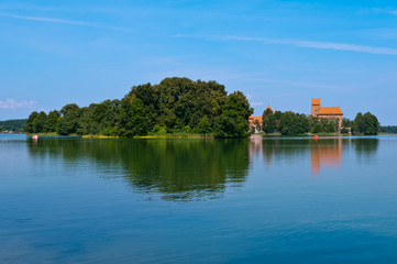 Fototapeta na wymiar Island with Trees in the Lake with Trakai Castle
