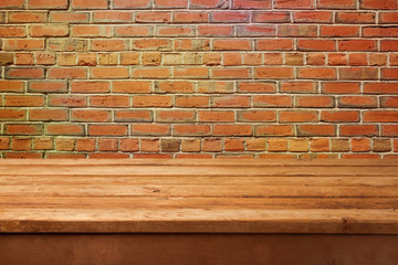 Empty wooden table and brick wall