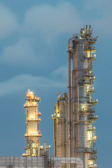 Column tower in petrochemical plant at twilight