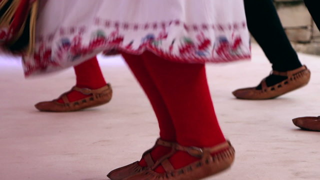 Bulgarian traditional dancers play in beautiful costumes