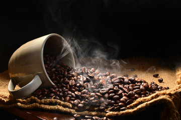 Coffee beans with smoke in coffee cup